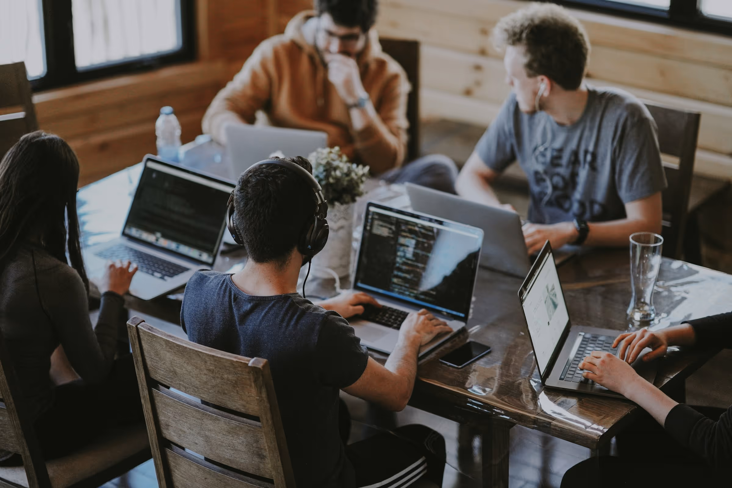 An agency team working on laptops around a table